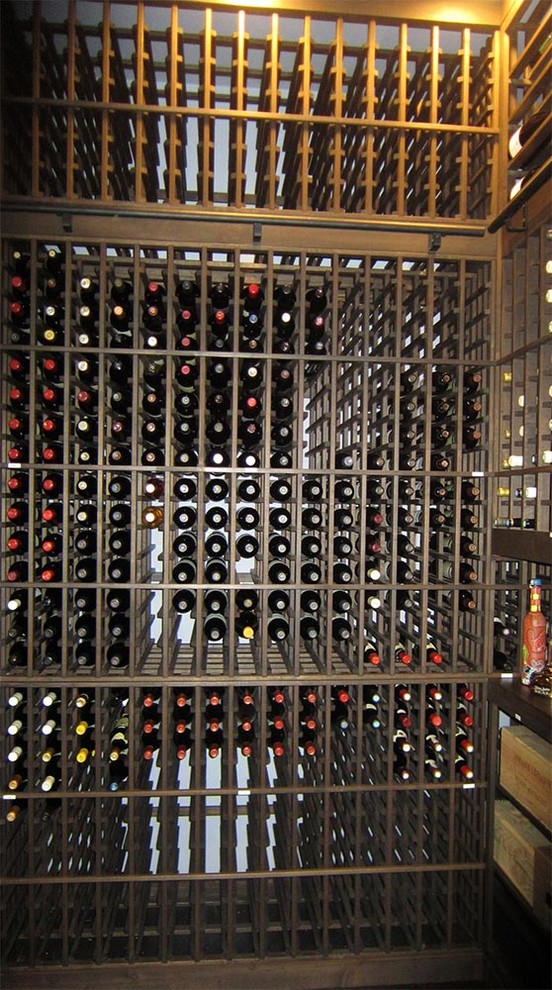 Inspiration for a mid-sized transitional wine cellar remodel in Dallas with storage racks