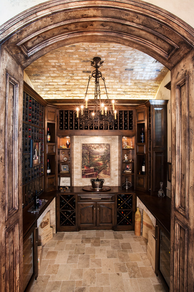 Elegant travertine floor wine cellar photo in Houston with storage racks