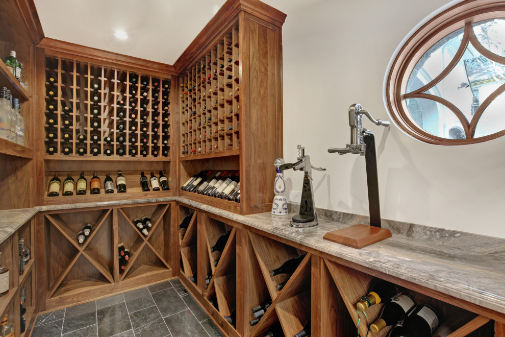 Mediterranean wine cellar in Dallas with cube storage and grey floors.
