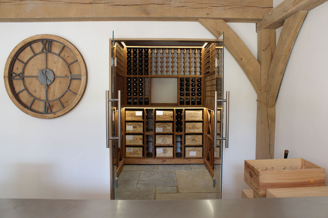 Medium sized wine cellar with glass door opening in West Sussex