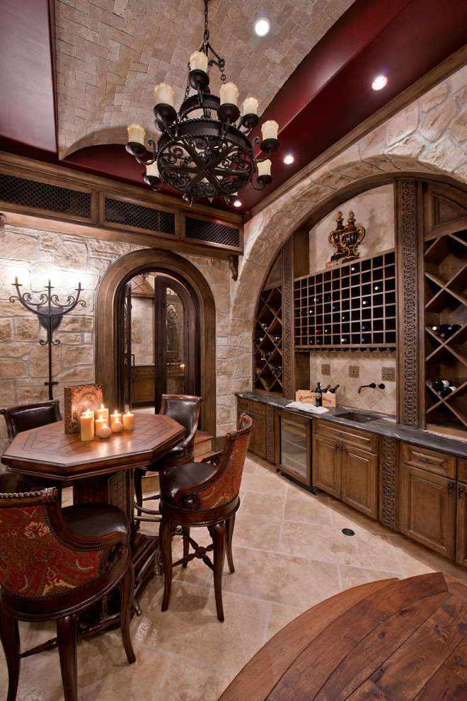 Inspiration for a traditional wine cellar in Houston with travertine flooring and cube storage.