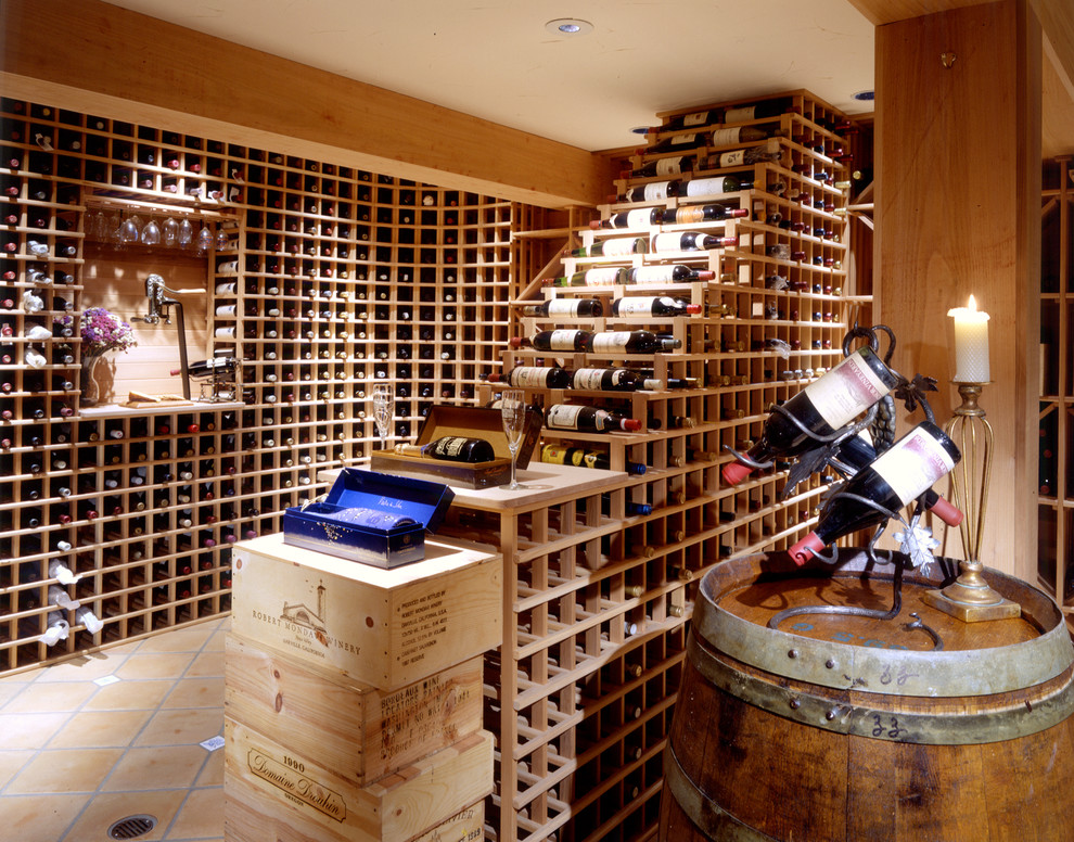 Wine cellar - traditional terra-cotta tile wine cellar idea in Seattle with storage racks