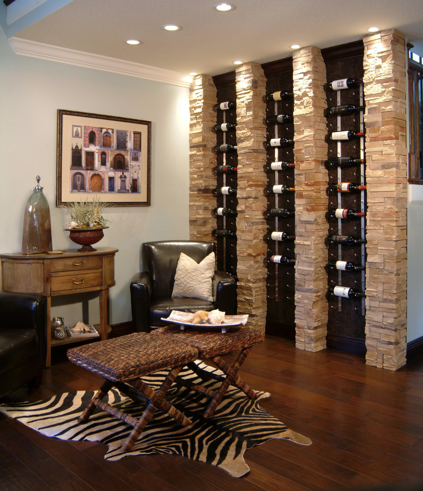 Wine cellar - transitional dark wood floor and brown floor wine cellar idea in Orlando with display racks