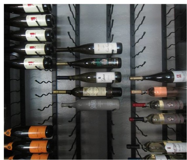 Metal Wine Cellar Racks Installed in a ClimateControlled Wine Room Contemporáneo Bodega
