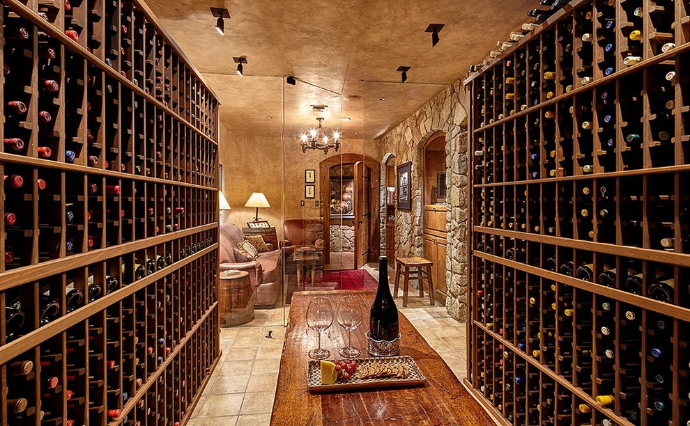 Photo of a classic wine cellar in Seattle with travertine flooring, storage racks and beige floors.