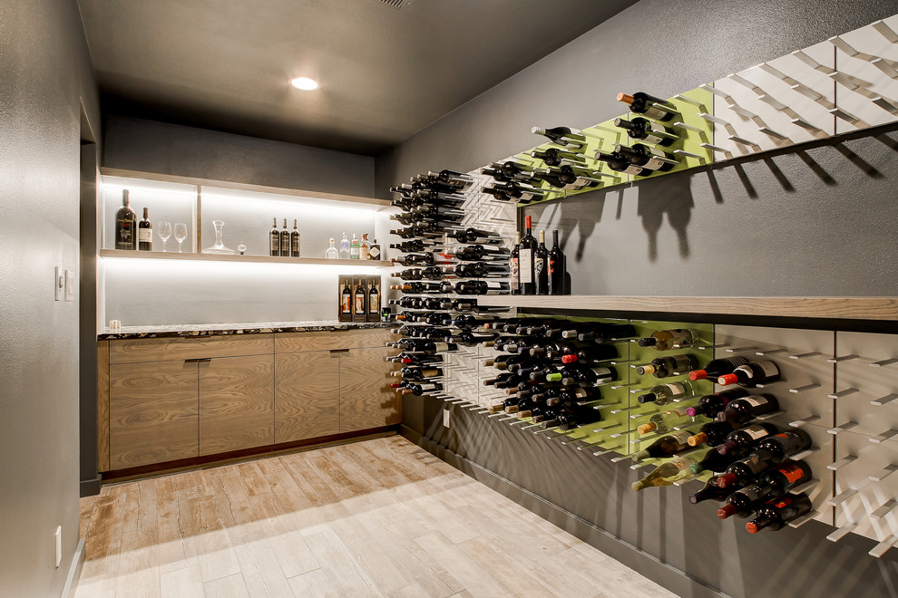 Inspiration for a 1950s light wood floor wine cellar remodel in Seattle with storage racks