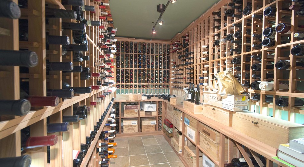 Inspiration for a mid-sized coastal porcelain tile wine cellar remodel in New York with storage racks