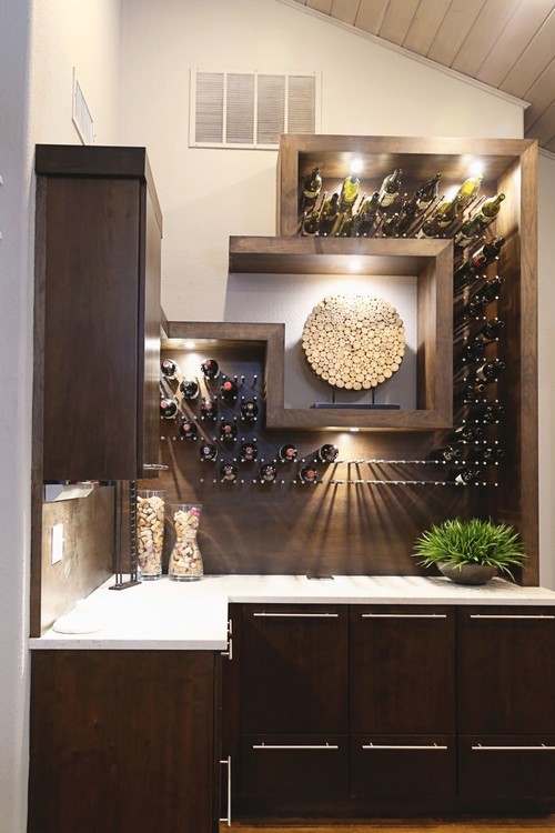 This is an example of a medium sized contemporary wine cellar in Other with light hardwood flooring and display racks.