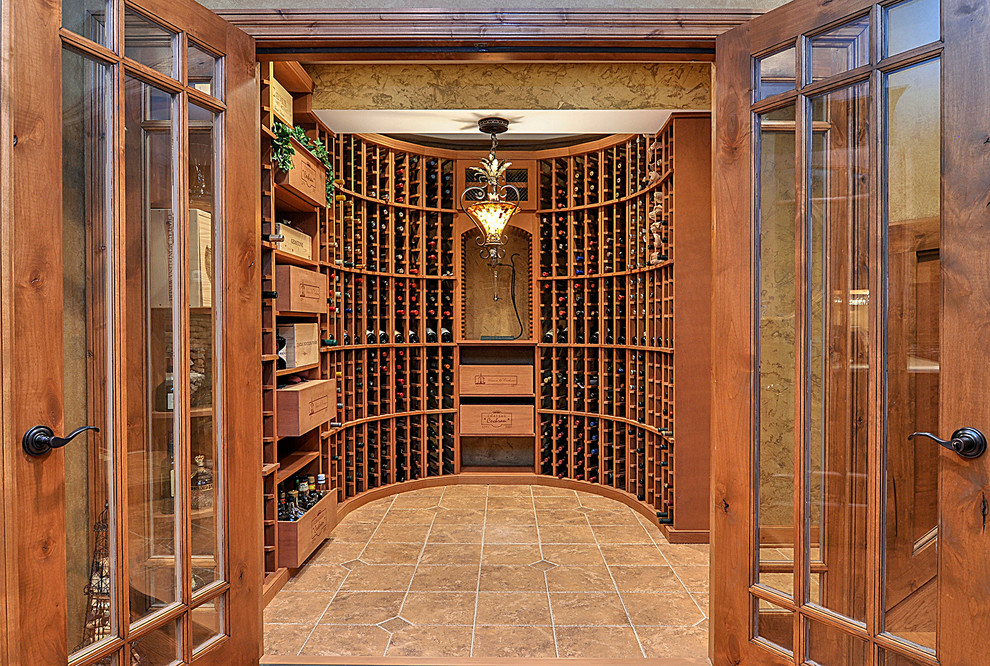 Wine cellar - large rustic porcelain tile wine cellar idea in Nashville with storage racks