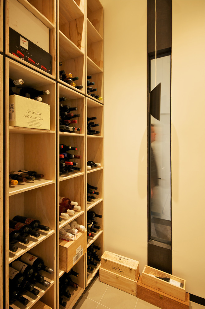 Design ideas for a contemporary wine cellar in Melbourne with beige floors.