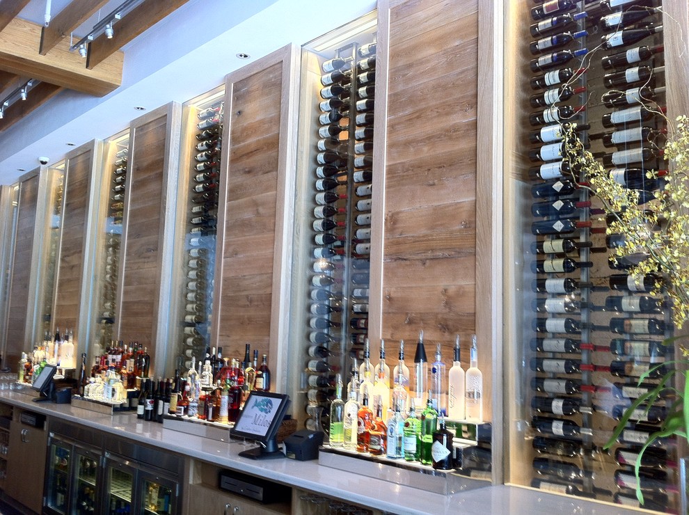 Small minimalist wine cellar photo in Miami with display racks