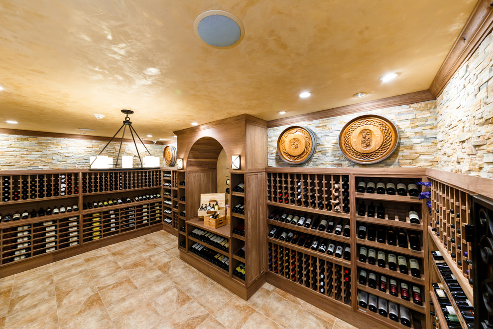 Photo of a large modern wine cellar in New York with porcelain flooring and display racks.