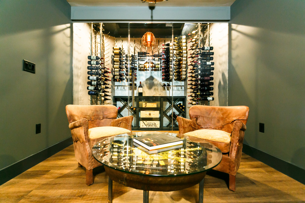 Medium sized contemporary wine cellar in New York with dark hardwood flooring and display racks.