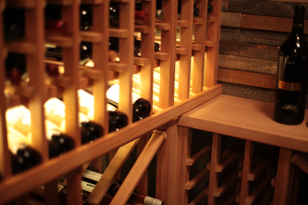 Medium sized classic wine cellar in Vancouver with storage racks and medium hardwood flooring.
