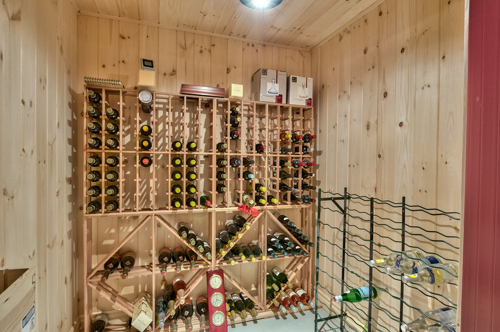 This is an example of a rustic wine cellar in Montreal with storage racks.