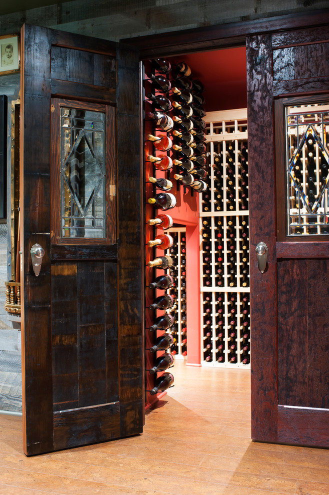 Photo of a small traditional wine cellar in Other with cork flooring and storage racks.