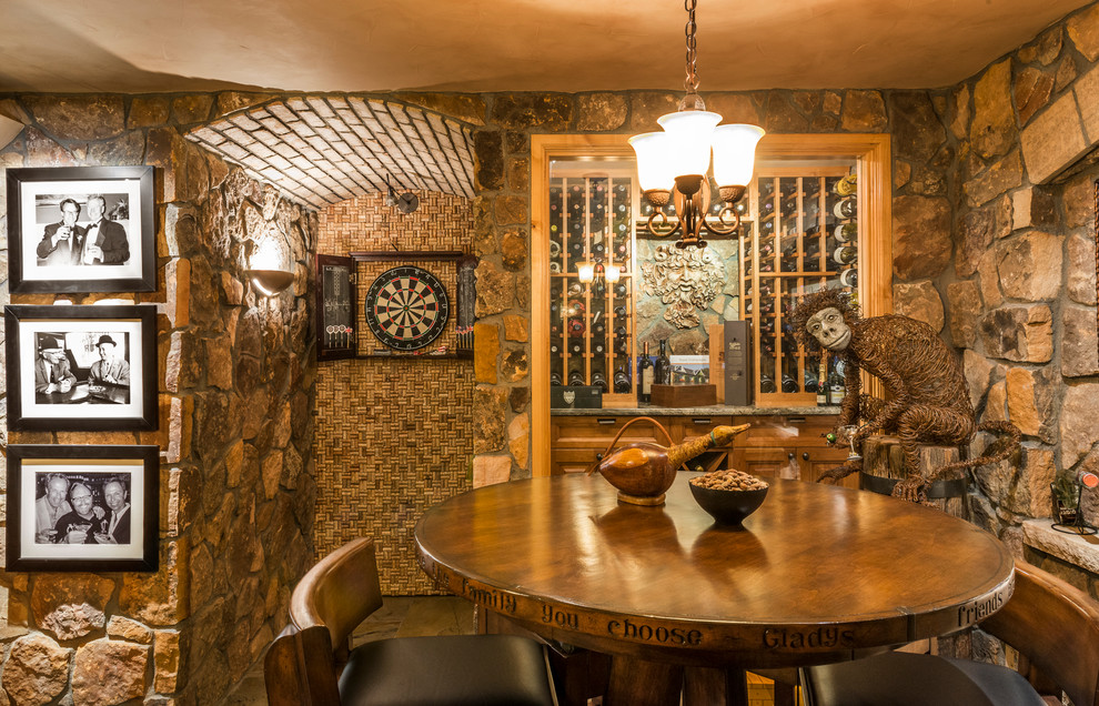 Photo of a rustic wine cellar in Denver with storage racks.