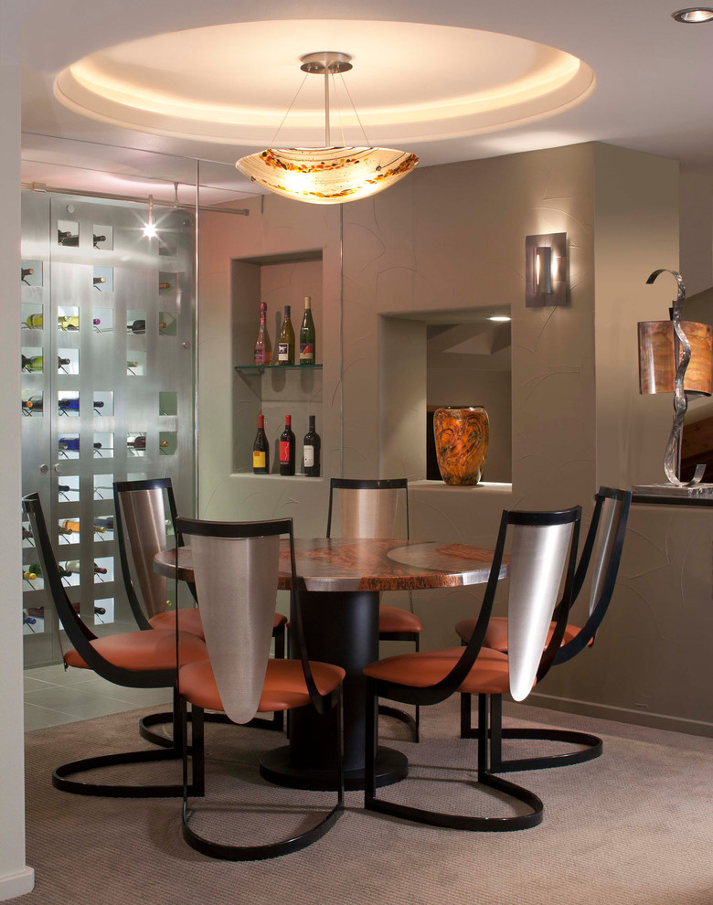 Inspiration for an expansive contemporary wine cellar in Denver with carpet, storage racks and beige floors.