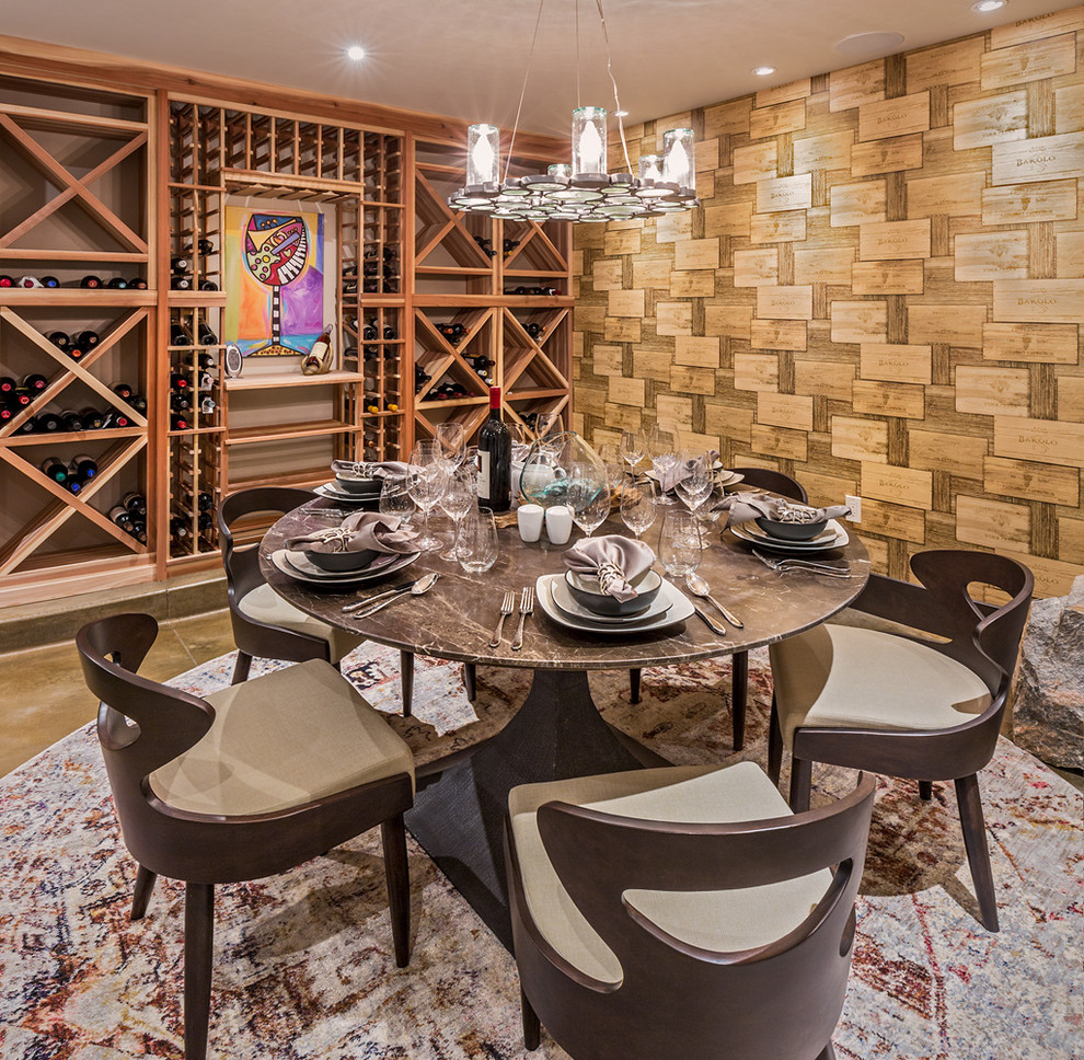 Photo of a large rustic wine cellar in Albuquerque with concrete flooring and storage racks.