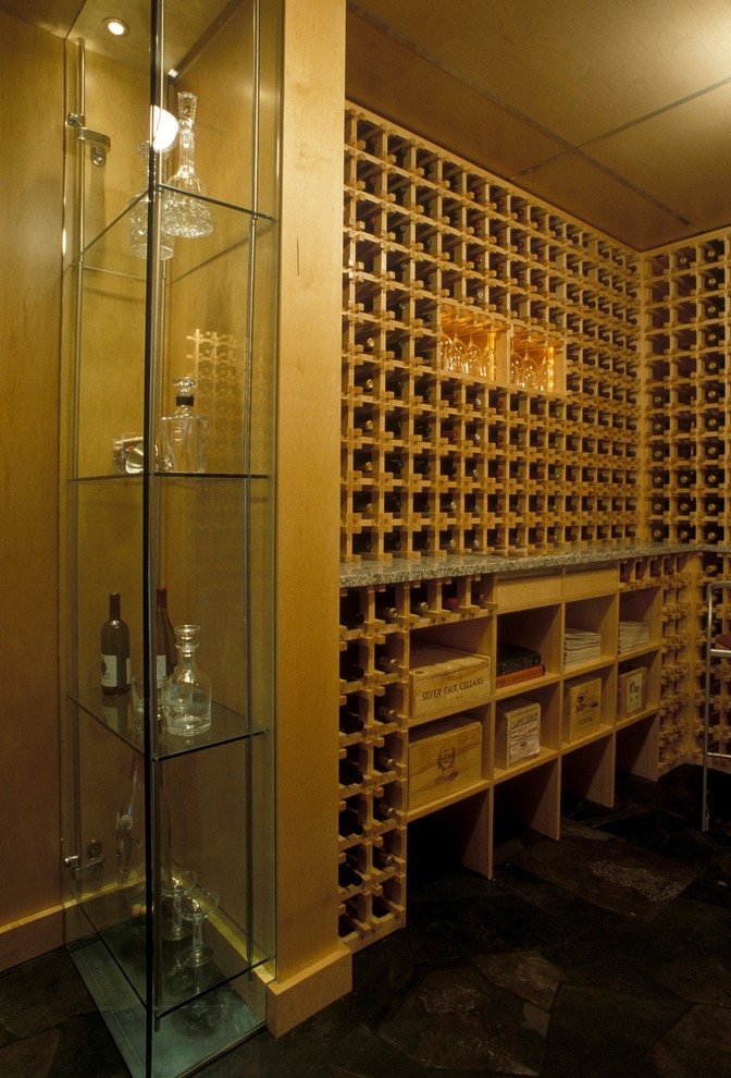 Mid-sized trendy slate floor wine cellar photo in Other with storage racks