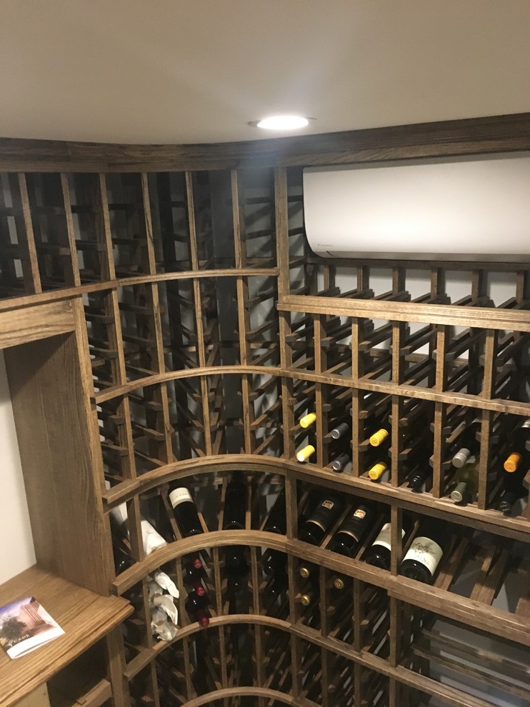 Mid-sized elegant porcelain tile and brown floor wine cellar photo in Cincinnati with storage racks