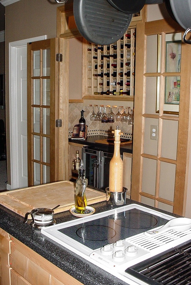 Example of a mid-sized trendy light wood floor wine cellar design in Other with display racks