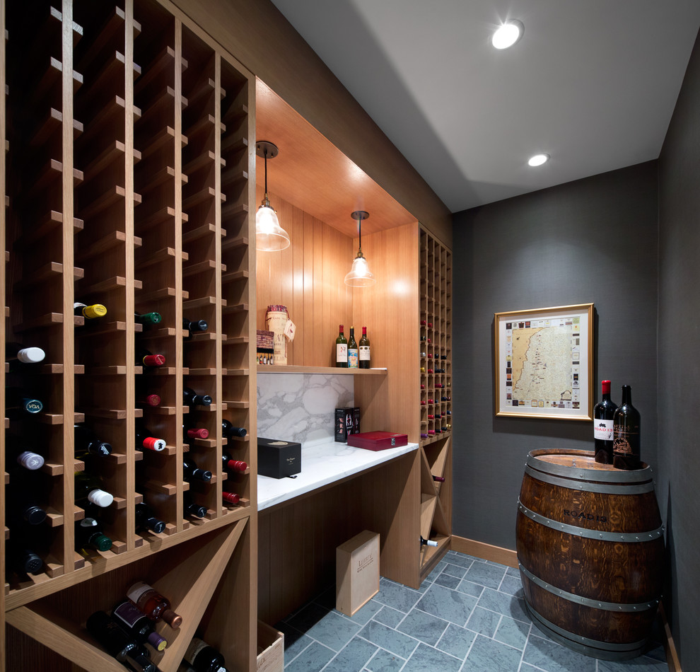 Wine cellar - traditional gray floor wine cellar idea in Vancouver with storage racks