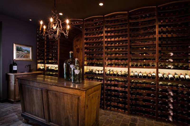 Example of a mid-sized mountain style ceramic tile wine cellar design in Orange County with storage racks