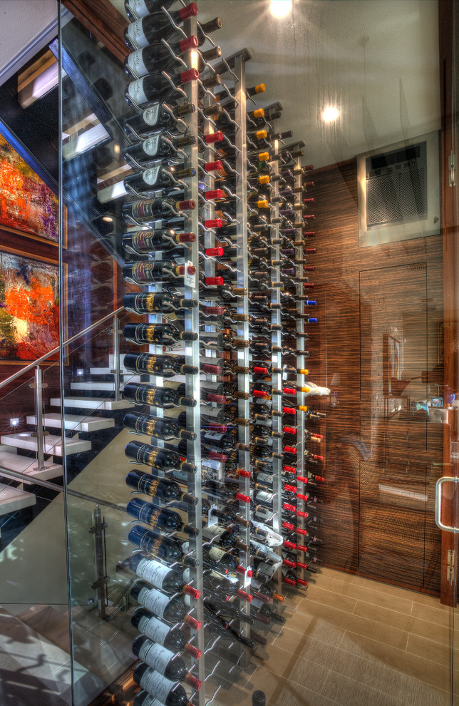 Example of a small minimalist porcelain tile wine cellar design in Tampa with storage racks