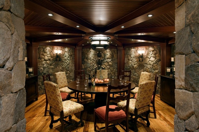 Large elegant medium tone wood floor wine cellar photo in Boston with display racks