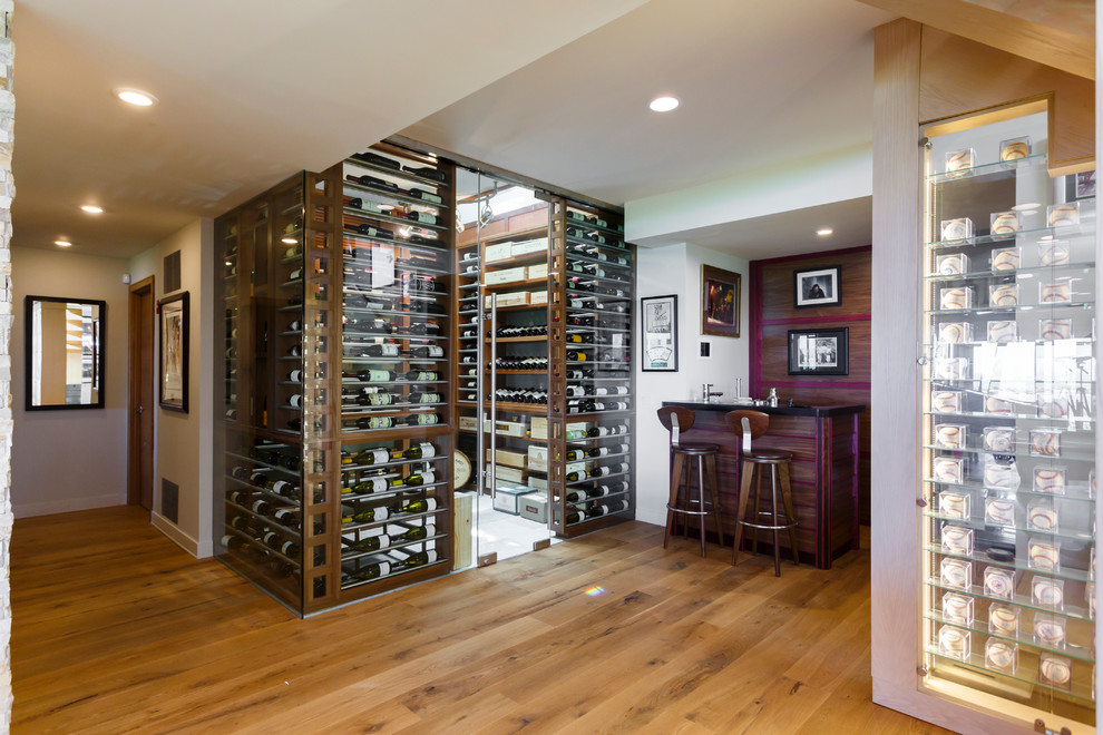 Large trendy marble floor wine cellar photo in New York with display racks