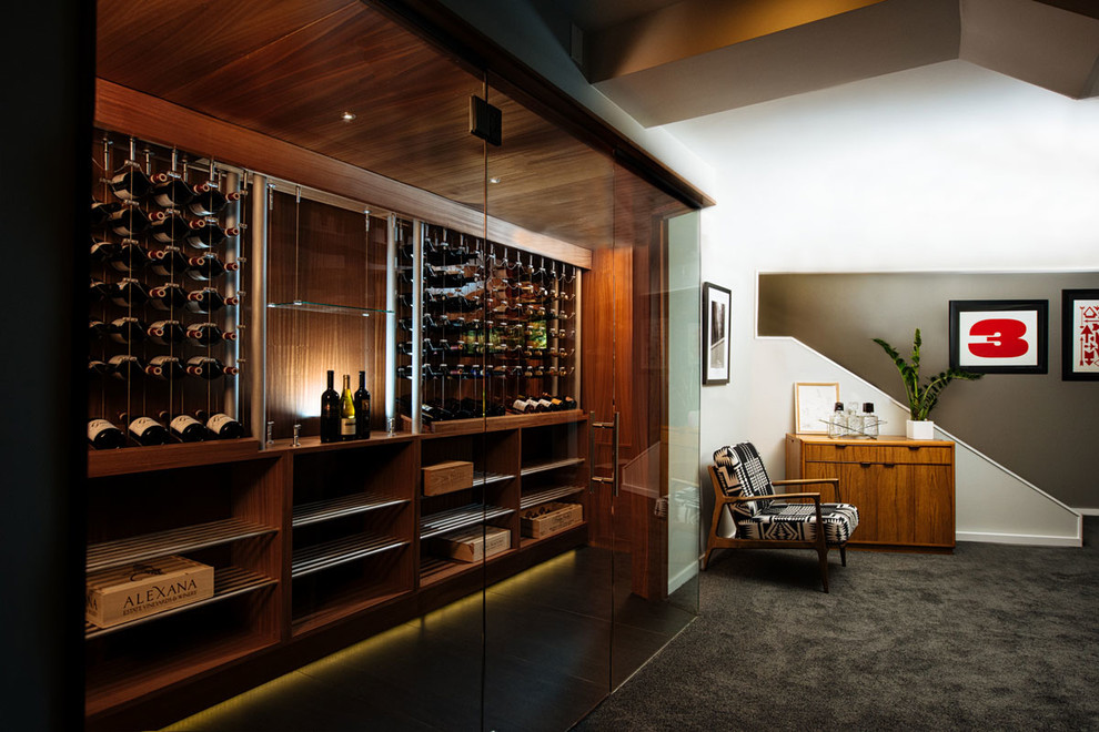 Inspiration for a modern wine cellar in Portland with laminate floors, grey floors and display racks.