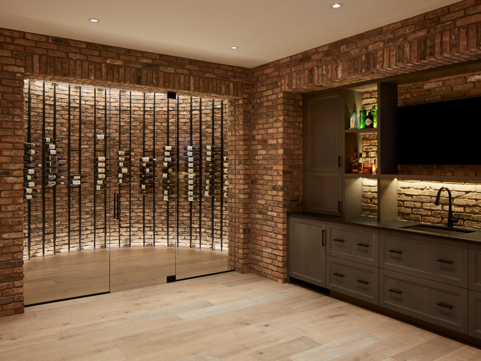 Inspiration for a large rural wine cellar in Chicago with light hardwood flooring, display racks and grey floors.