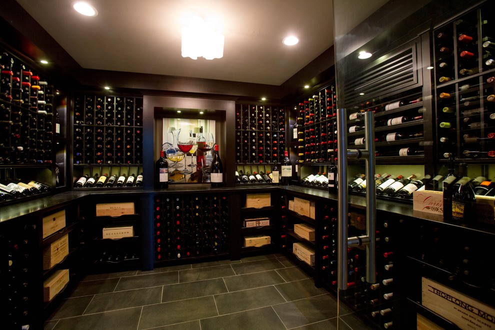 This is an example of a classic wine cellar in Boston with ceramic flooring and display racks.