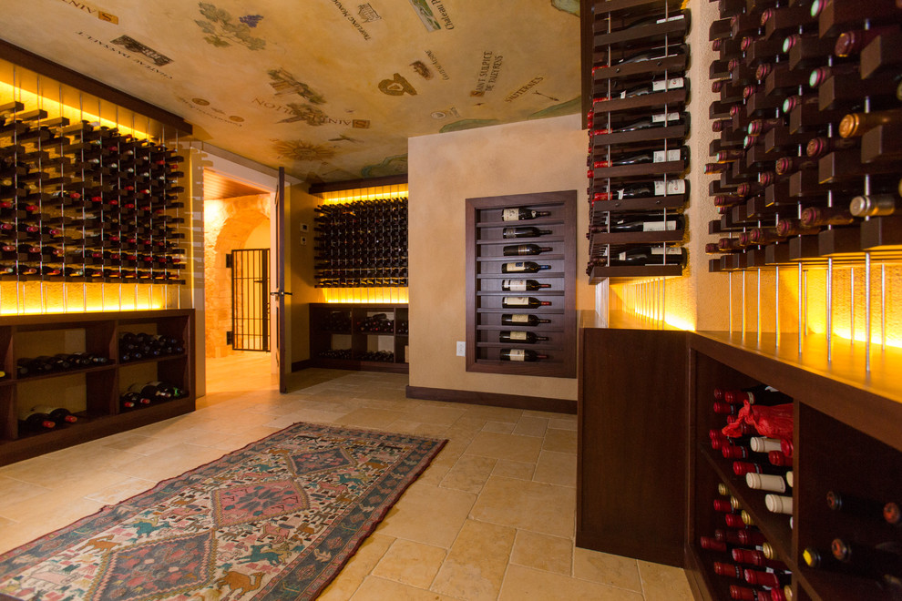 Inspiration for a huge mediterranean limestone floor and beige floor wine cellar remodel in Boston with storage racks