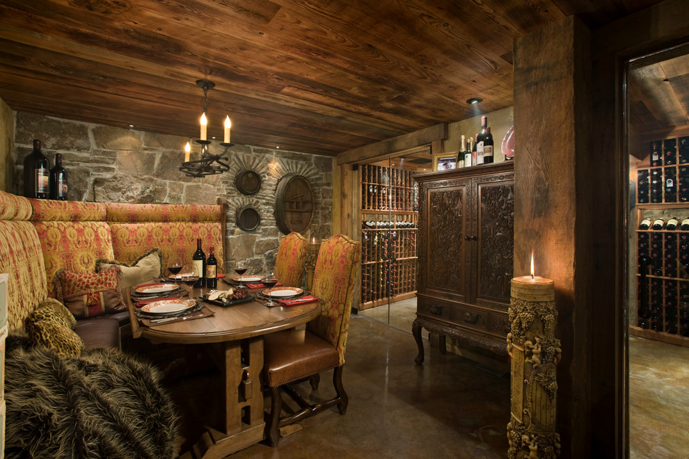 This is an example of a rustic wine cellar in Other with concrete flooring.