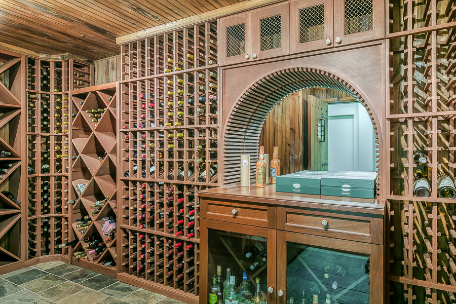 Inspiration for a large wine cellar in Miami with ceramic flooring, storage racks and turquoise floors.
