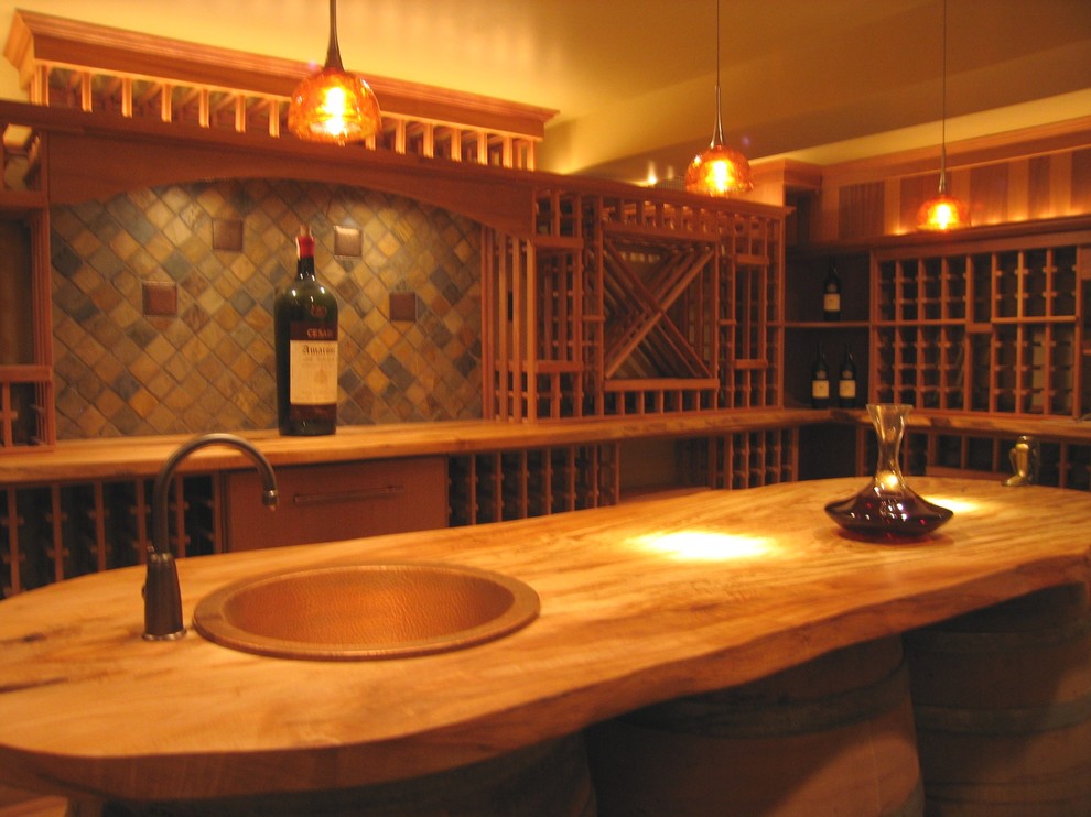 Mid-sized mountain style travertine floor wine cellar photo in Seattle with storage racks