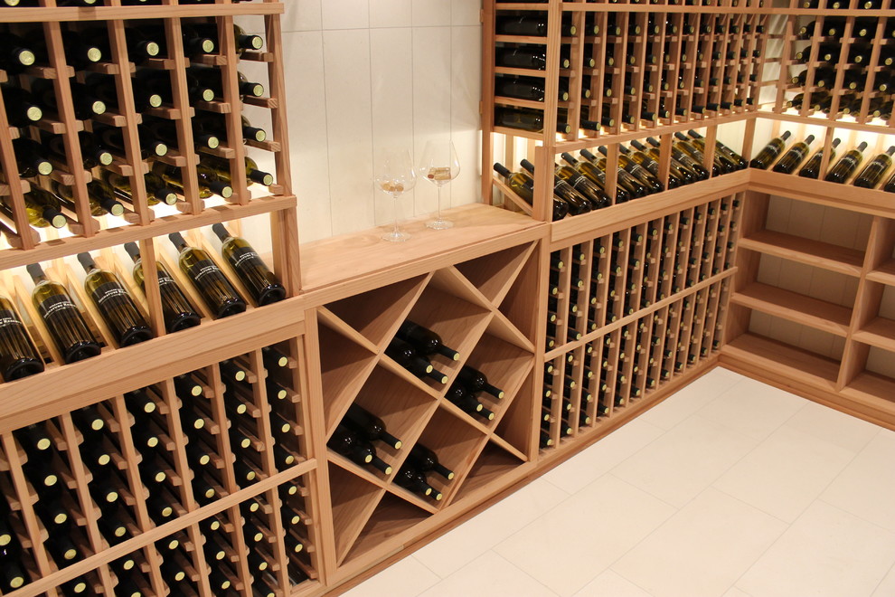 Inspiration for a mid-sized contemporary travertine floor wine cellar remodel in Orange County with storage racks