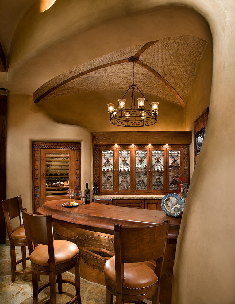 This is an example of a wine cellar in Phoenix with beige floors and display racks.