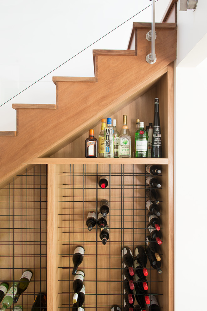 This is an example of a small contemporary wine cellar in Sunshine Coast with storage racks.