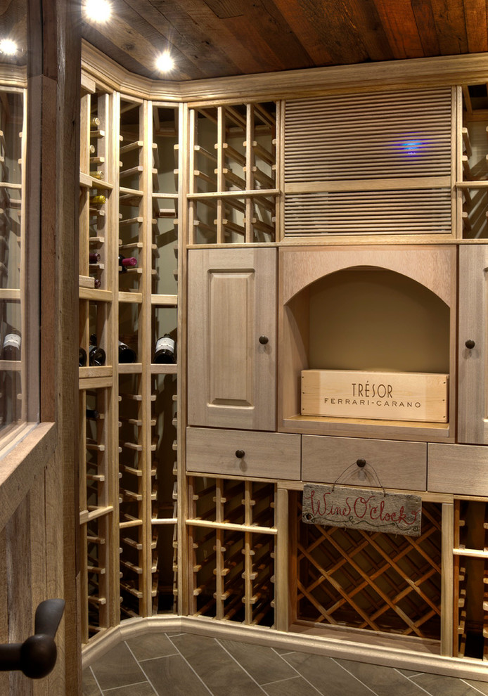 Inspiration for a medium sized rustic wine cellar in Minneapolis with ceramic flooring and display racks.