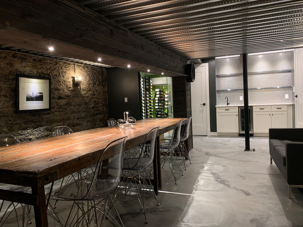 Design ideas for a small bohemian wine cellar in Cincinnati with concrete flooring, display racks and grey floors.