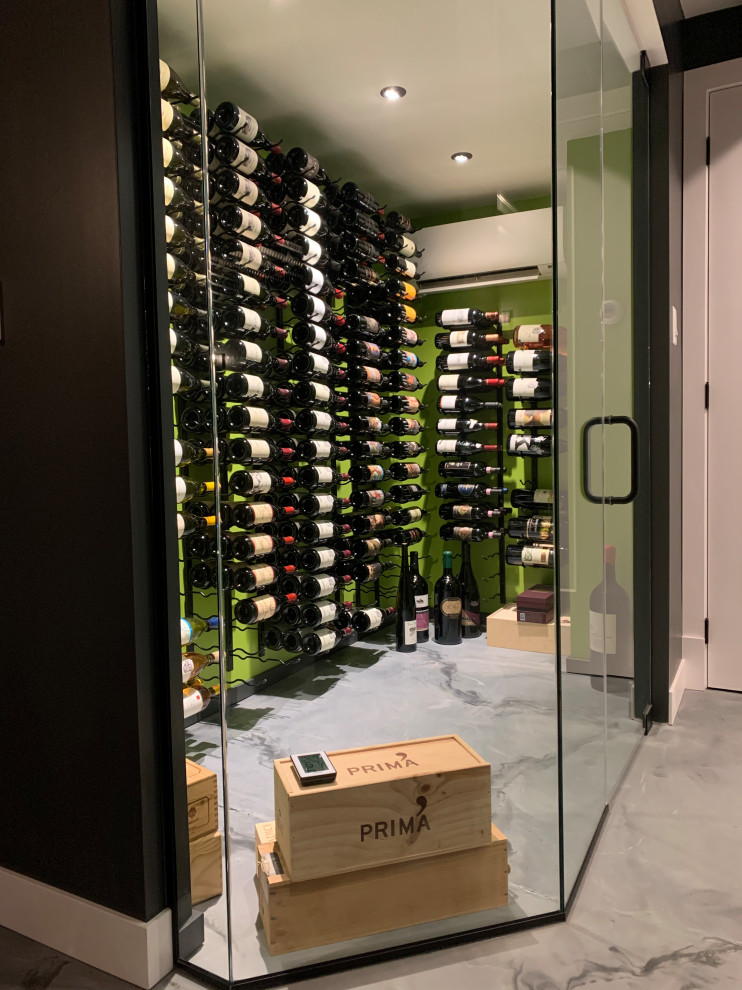 Photo of a small eclectic wine cellar in Cincinnati with concrete flooring, display racks and grey floors.