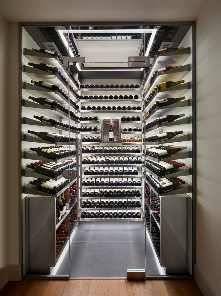 Cette image montre une cave à vin design avec des casiers et un sol gris.