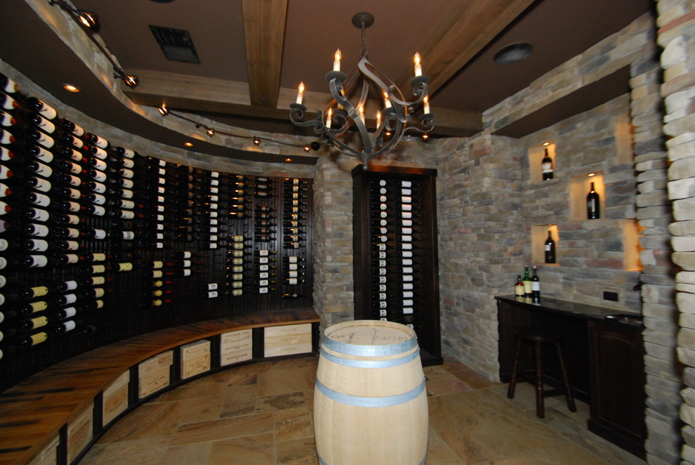 Example of a large tuscan slate floor wine cellar design in Raleigh with display racks