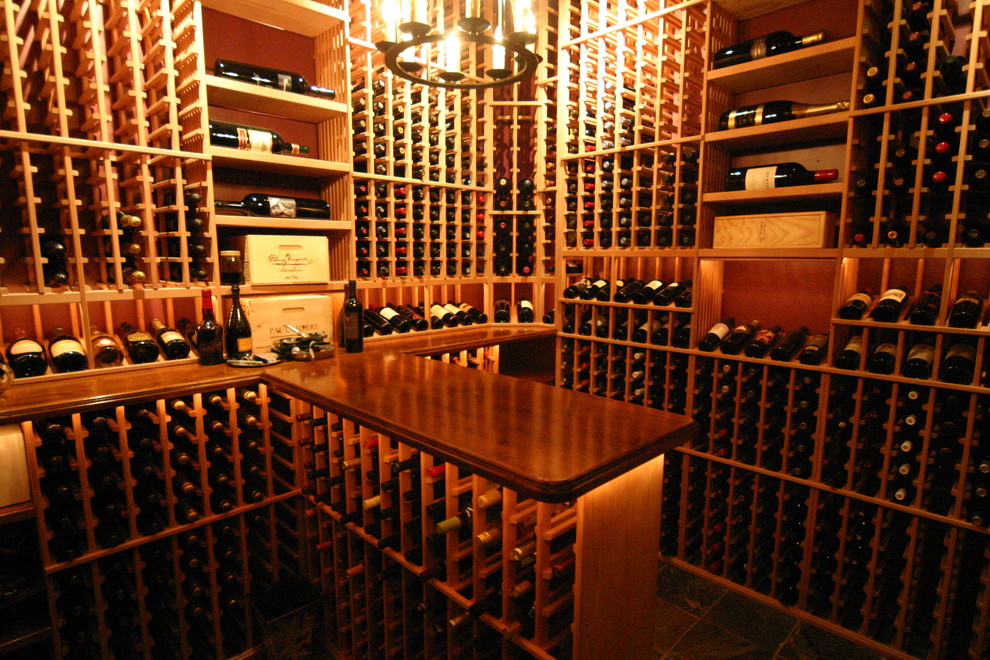 Medium sized traditional wine cellar in Sacramento with ceramic flooring, storage racks and grey floors.