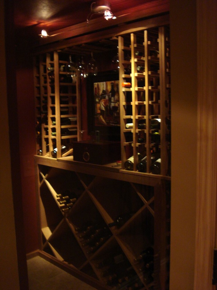 This is an example of a small mediterranean wine cellar in Salt Lake City with display racks, ceramic flooring and beige floors.