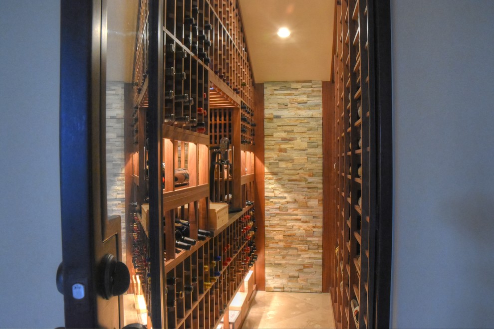 Example of a mid-sized classic terra-cotta tile wine cellar design in Los Angeles with display racks