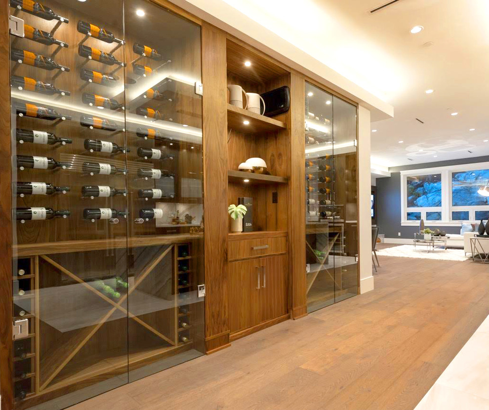 Mid-sized trendy medium tone wood floor wine cellar photo in Vancouver with storage racks